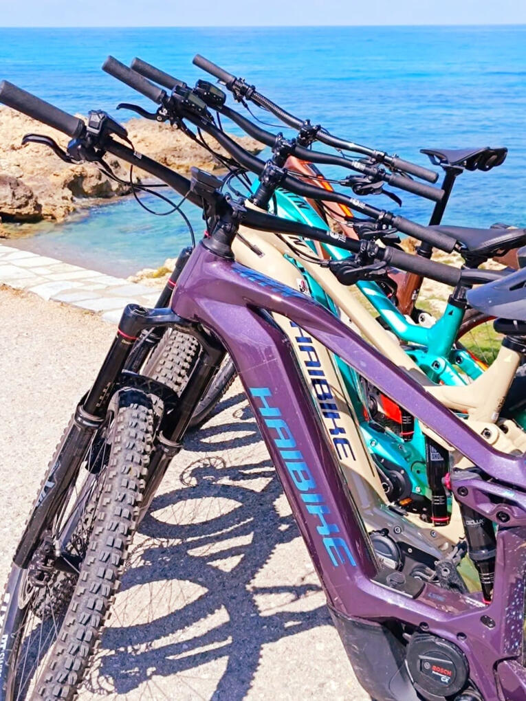 Premium electric mountain bikes Premium electric mountain bike parked at the beach in Greece
